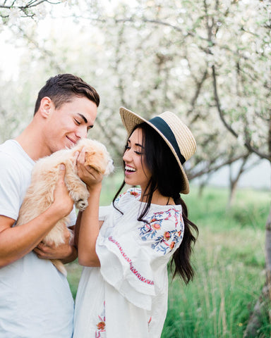 Girl, boy, and dog posing for family photos in an orchard